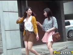 Asian babes squat and piss in public toilet